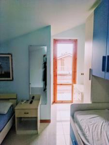 a bedroom with a bed and a desk and a mirror at Via Luigi Einaudi 53- Guest House in Pedaso +7 photos