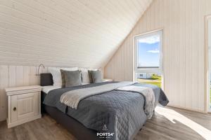 a bedroom with a bed and a window at Ferienhaus Strandläufer Olpenitz in Olpenitz