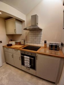 a kitchen with a stove and a stove top oven at The Herons in Goldsborough
