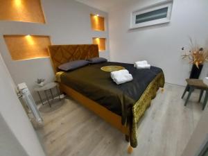 a bedroom with a bed with two towels on it at Sarajevo apartman Ilidza Springs parking free in Sarajevo