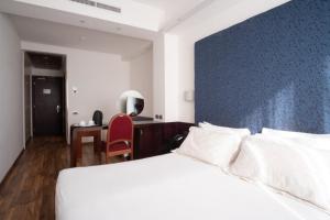 Łóżko lub łóżka w pokoju w obiekcie Hotel IMPERATORI
