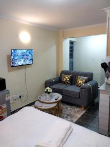 a living room with a couch and a tv at Ivy Kendra Kamakis in Ruiru
