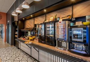 a fast food restaurant with a counter with food at B&B HOTEL Bordeaux Bassins à flot in Bordeaux