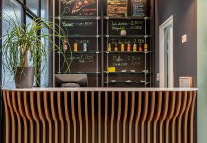a bar in a restaurant with a chalkboard at B&B HOTEL Bordeaux Bassins à flot in Bordeaux