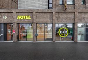 a hotel sign in the windows of a brick building at B&B HOTEL Bordeaux Bassins à flot in Bordeaux