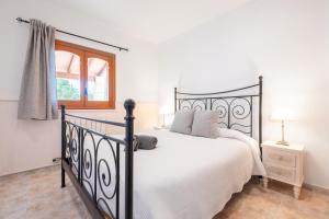 a bedroom with a black and white bed and a window at Finca Sant Blai Nou in Campos +28 photos