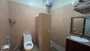 a bathroom with a toilet and a sink at Lush Garden Hostel in Arusha +5 photos