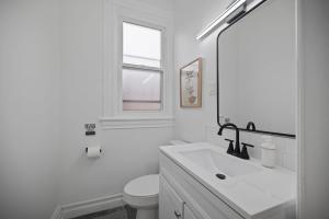 a white bathroom with a sink and a toilet at Shadyside, Pittsburgh !F Modern and Bright Private Bedroom with Shared Bathroom in Pittsburgh +8 photos