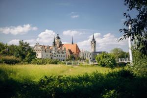 a large white building in the middle of a field at gemütliches Stadtloft in Dessau in Dessau
