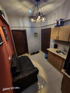 a bathroom with a couch and a sink in a room at Imperium luxe in Karachi +17 photos