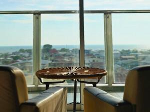 a table sitting in front of a large window at Enjoy the Unblocked Seaview 超大海景房 5mins to Paddy Fields and Pantai Redang in Sekincan