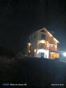 a house on the beach at night at Jay Amrut Home stay in Ratnagiri