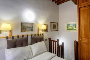 a bedroom with a bed with white pillows at Puccini Flat in Rome