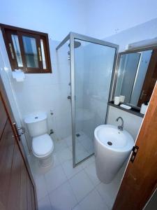 a bathroom with a shower and a toilet and a sink at Paradis Appartement in Ngor