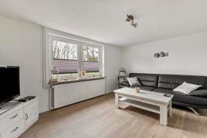a living room with a couch and a coffee table at Ferienhaus Angela in Neuenkirchen