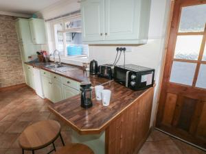 a kitchen with a counter with a microwave on it at Carreg Yr Onnen in Haverfordwest