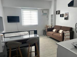a living room with a couch and a table at Tiny Haven Room in Tunkong Manga