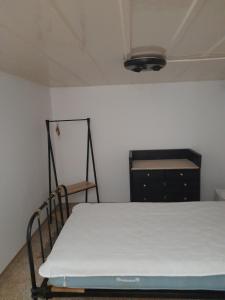 a room with a bed and a dresser in it at Marielli's house in Ermoupoli