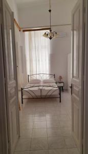 a bedroom with a bed in the middle of a room at Marielli's house in Ermoupoli