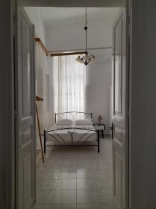 a bedroom with a bed in the middle of a room at Marielli's house in Ermoupoli