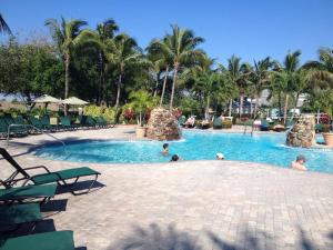 a pool at a resort with people in the water at Greenlinks Naples Florida Condo in Naples