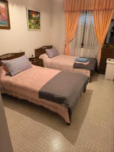 En eller flere senge i et værelse på Casa familiar Sanabria