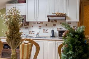 a kitchen with white cabinets and a christmas tree at Lions Heart Hostel in Lviv