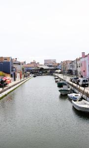 a group of boats docked in a river with buildings at Fisherman's View in Aveiro