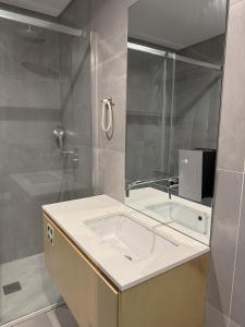 a bathroom with a sink and a shower at Fisherman's View in Aveiro