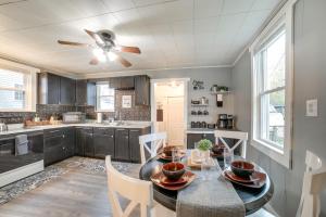 a kitchen with a dining table and a ceiling fan at 2 Mi to Saint Vincent College Home in Latrobe in Latrobe
