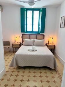 Postel nebo postele na pokoji v ubytování Hostal El Faro