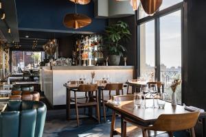a restaurant with tables and chairs and a bar at Terrass" Hotel in Paris