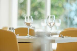 two glasses of wine sitting on a table at Bahia Principe Escape Coral Playa Adults Only in Magaluf