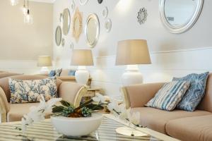 a living room with two couches and a table at Bahia Principe Escape Coral Playa Adults Only in Magaluf