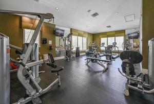 a gym with several treadmills and exercise machines at Greenlinks Naples Florida Condo in Naples