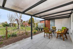 a patio with chairs and a table on a patio at Ferienhaus Angela in Neuenkirchen
