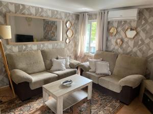 a living room with two couches and a coffee table at Marbella Apartment in Marbella