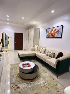 a living room with two couches and a coffee table at 1 bedroom Shortlet Apt at Osapa London Lekki in Lagos