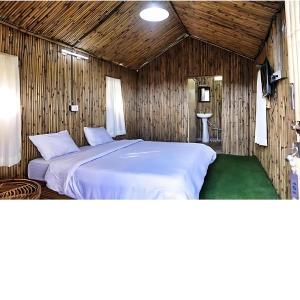 a bedroom with a large bed in a wooden room at Mahadev Nature Treat Hotel in Shimla Airport