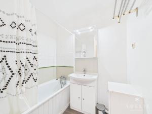 a white bathroom with a sink and a tub and a shower at Studio confortable au centre, proche remontées mécaniques - FR-1-398-573 in Montvalezan