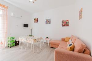 a living room with a couch and a table at Disiu Case Vacanza - Balestrate in Balestrate