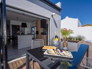 a table with a tray of food on top of a house at Studio 56 in Langebaan