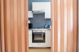 a kitchen with white cabinets and an oven at Padova Umberto center appartments in Padova