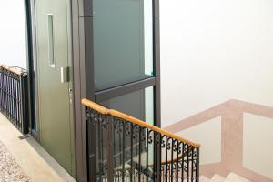 a stairwell with a green door and a glass window at Padova Umberto center appartments in Padova