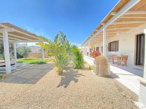 a patio of a house with a table and chairs at Symphony Sound Villa with Pool in Chiesanuova
