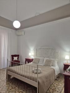 a bedroom with a large bed and two chairs at La Mattanza in Trapani