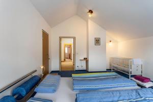 a bedroom with two beds and a hallway at Haus Waldblick in Bad Berleburg