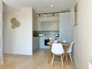 a kitchen with a table and chairs in a room at Homi Host- JQ inn monthly stay in Birmingham +16 photos