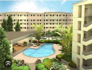 an overhead view of a building with a swimming pool at Poolside Apartment - Sleeps 4 Ac & Hot Shower in Marilao
