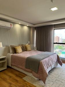 Кровать или кровати в номере Hotel Flat Afonso Pena e Centro de Convenções Campo Grande